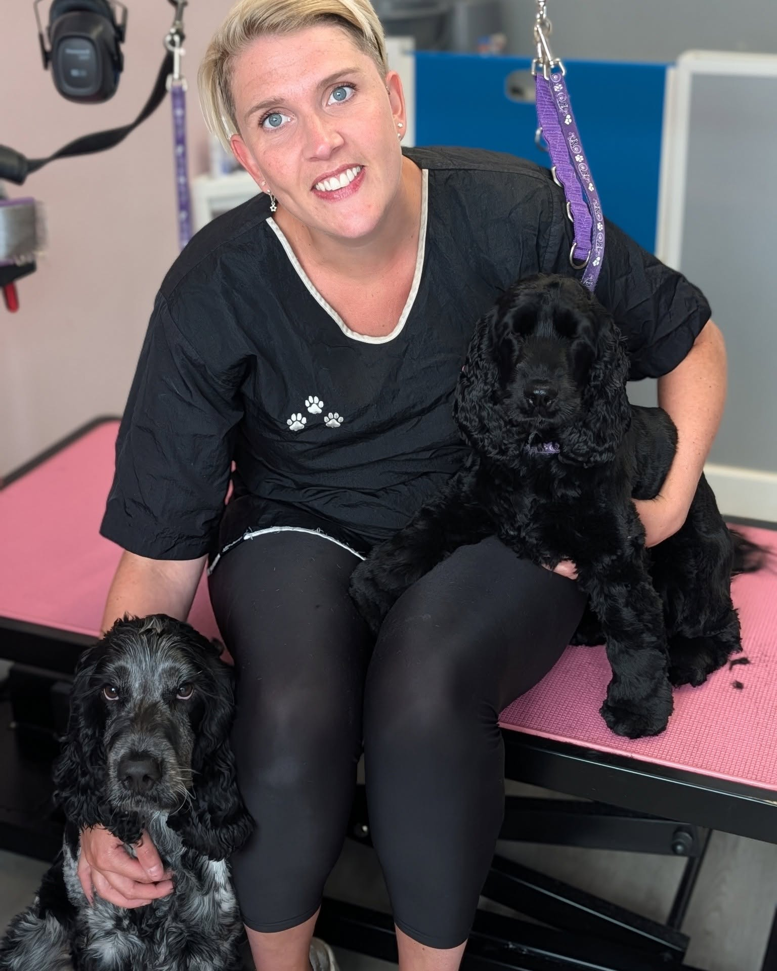 Jo with two dogs in the grooming salon